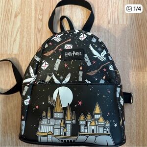 Funko Harry Potter backpack. Black background with gold castle and white owls